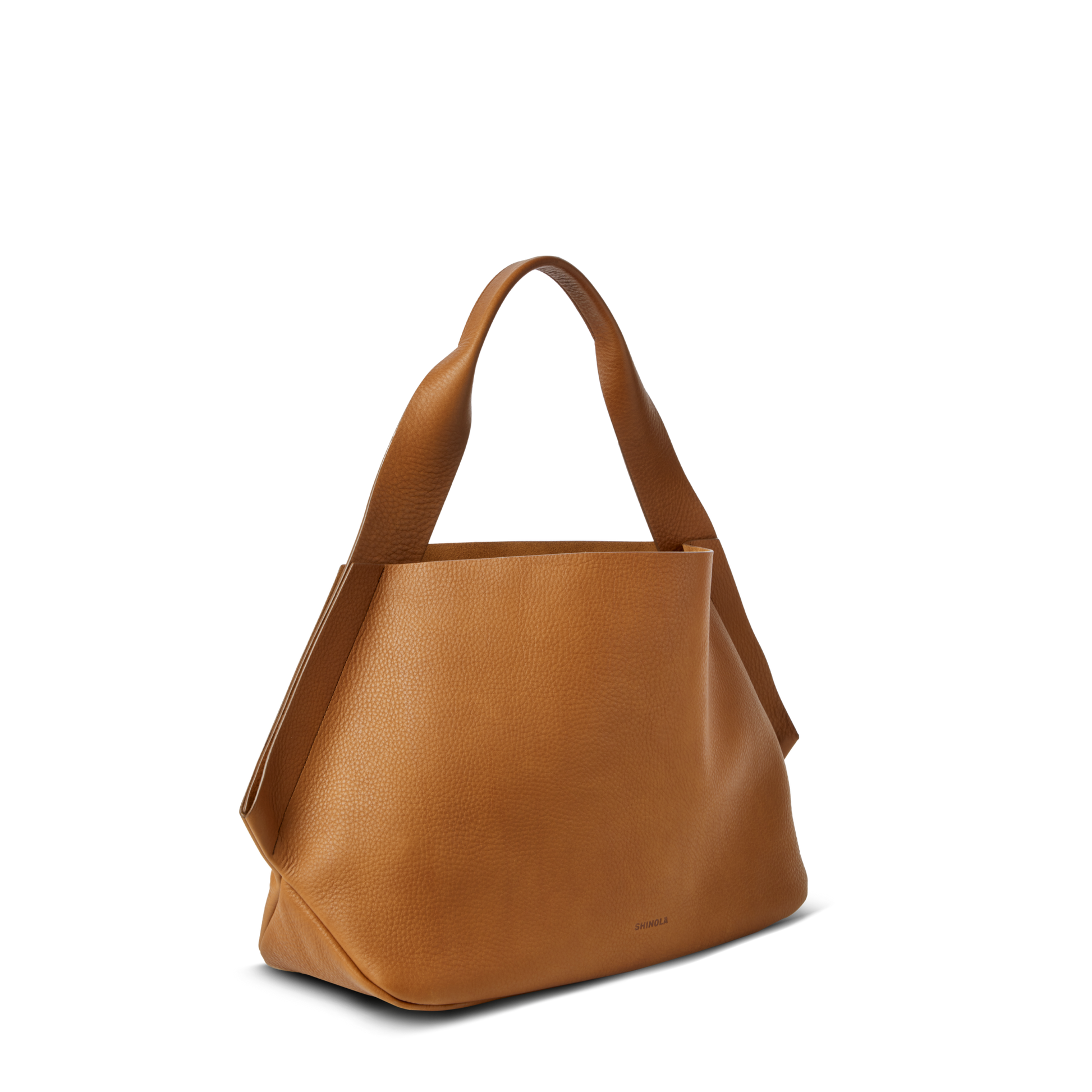The Shinola Derby Shoulder Bag - Tan is a spacious tote with a wide base, structured sides, two sturdy handles, and a leather card pocket, shown on a plain white background.