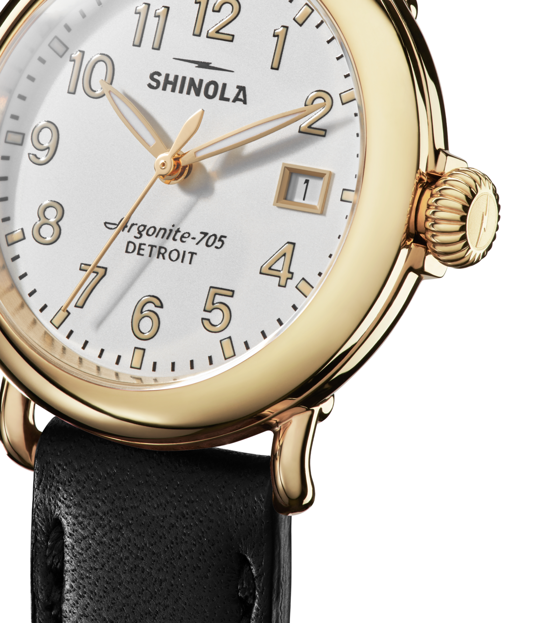 Close-up of the Shinola Runwell Watch - Alabaster featuring a gold stainless steel case, white face with black numerals, gold hands, date window, and black leather strap. The dial reads Argonite-705 DETROIT.