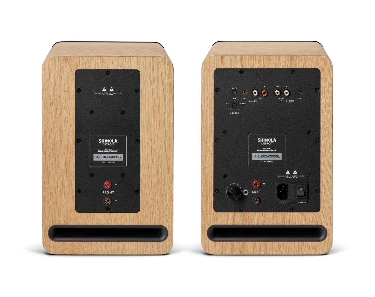The Shinola Bluetooth Bookshelf Speakers - Natural are shown from the back, featuring input/output ports, a control panel, and right/left labels on a plain background.