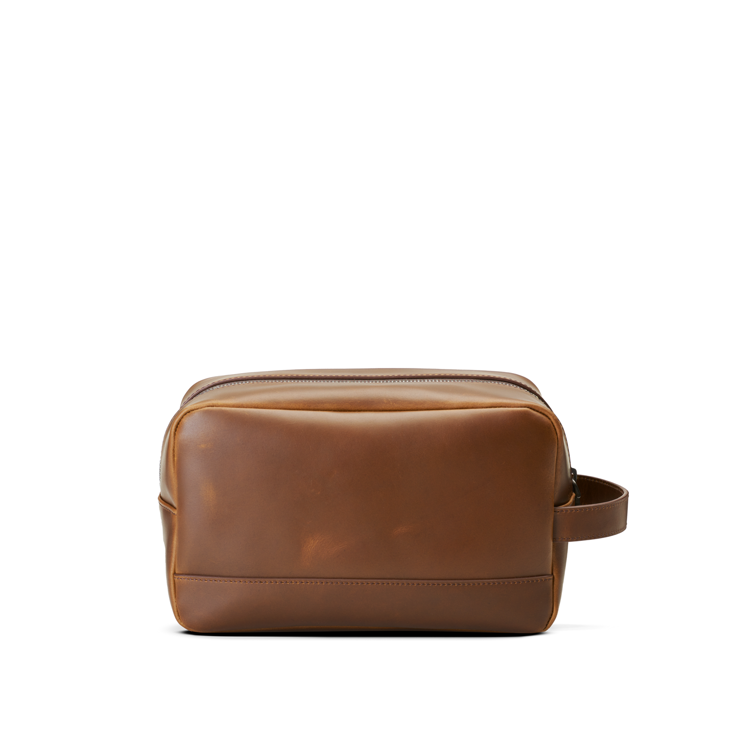 The Shinola Zip Travel Kit - Medium Brown is a stylish, water-resistant leather toiletry bag with a zippered top and side handle, shown against a plain white background.