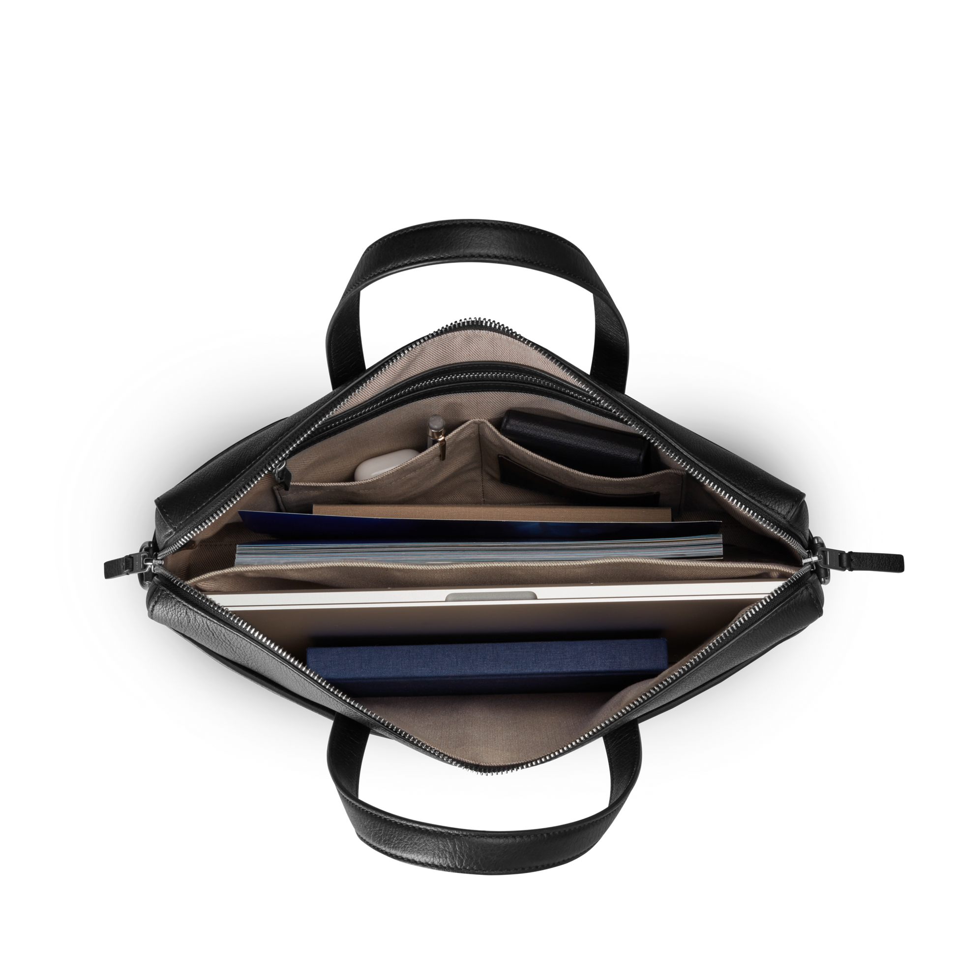 Top view of the Shinola Canfield Briefcase - Black Pebbled Leather, with organized compartments holding a laptop, notebook, folder, glasses case, pen, and essentials—ideal for commuters. Shown against a white background.