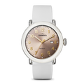 The Shinola Detrola Watch - Nude features a round, rose-gold dial with gold numerals and hands, a small date window, and a white leather strap, embodying classic American design.