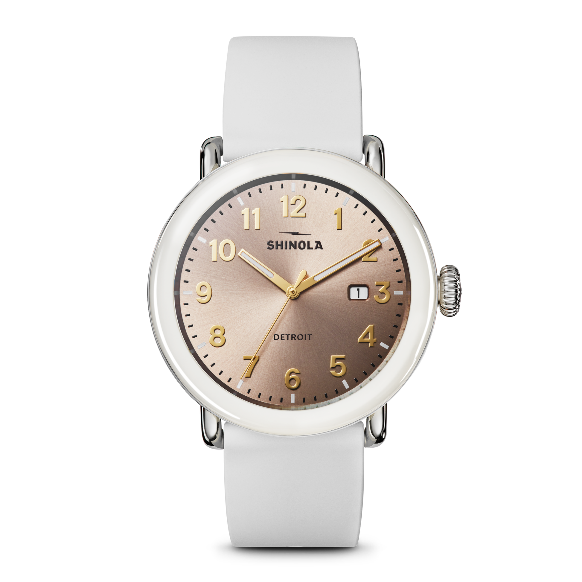 The Shinola Detrola Watch - Nude features a round, rose-gold dial with gold numerals and hands, a small date window, and a white leather strap, embodying classic American design.