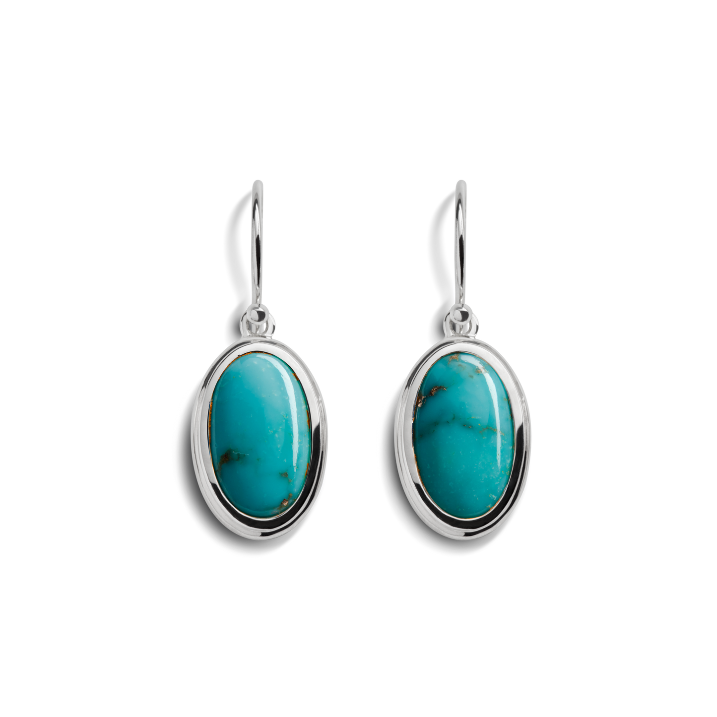 The Shinola Heirloom Drop Turquoise Earrings feature oval turquoise stones set in sterling silver frames with simple hooks, showcased on a white background.