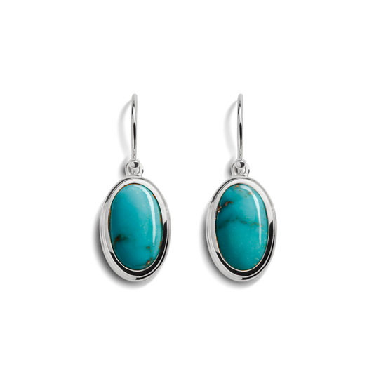 The Shinola Heirloom Drop Turquoise Earrings feature oval turquoise stones set in sterling silver frames with simple hooks, showcased on a white background.