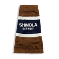The Dog Sweater - Brand Stripe / Tan from Shinola features brown, white, and navy stripes with "Shinola Detroit" in white text on the central navy stripe.