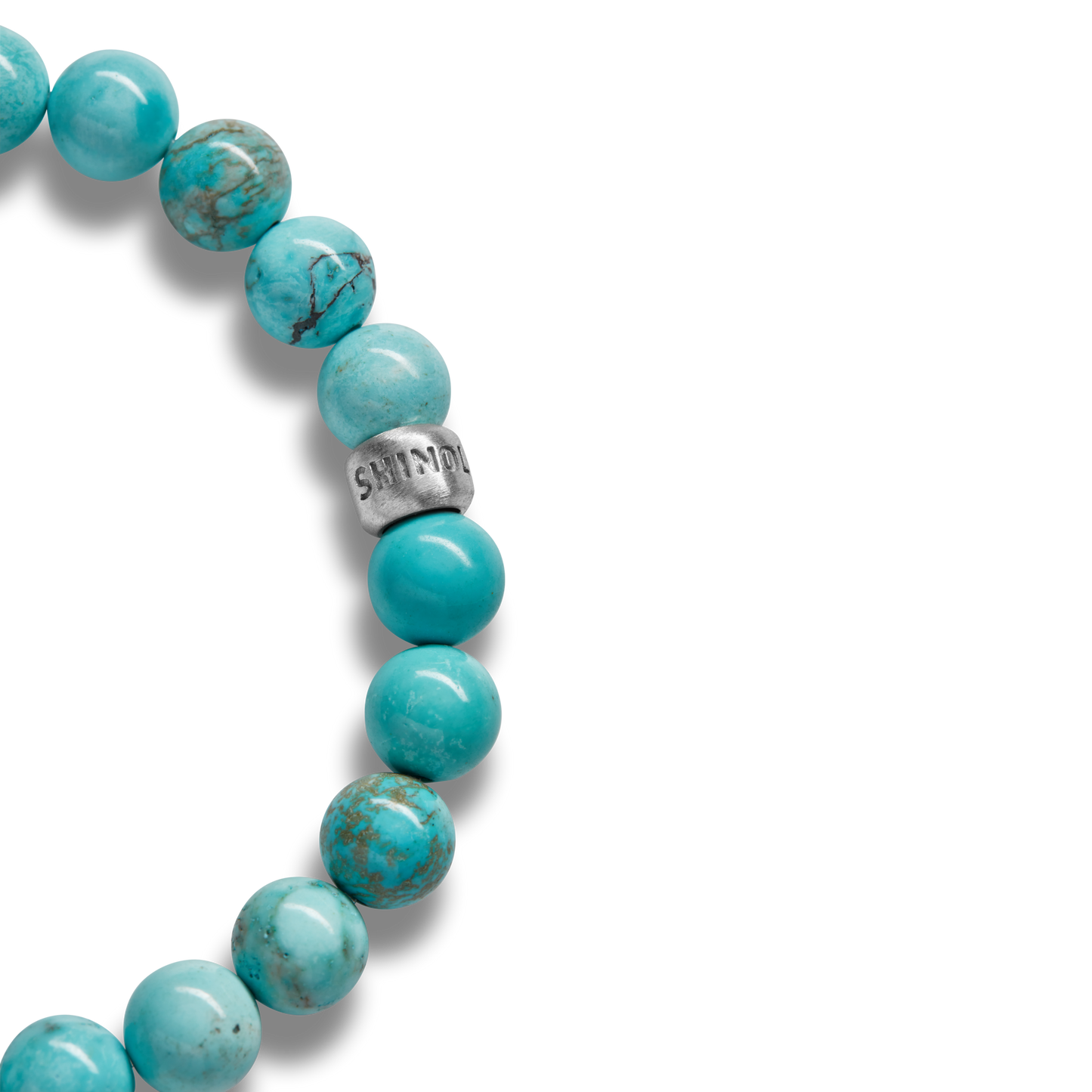 Close-up of the Shinola 8mm Beaded Bracelet Turquoise, featuring turquoise 8mm beads and a sterling silver accent engraved with SHINOLA, displayed on a white background.