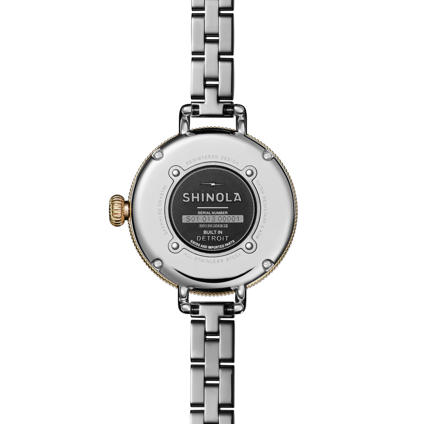 Close-up of the back of a Shinola Birdy Watch – Petoskey, featuring a two-tone gold and stainless steel case, metal link band, and visible serial number plate labeled Built in Detroit.