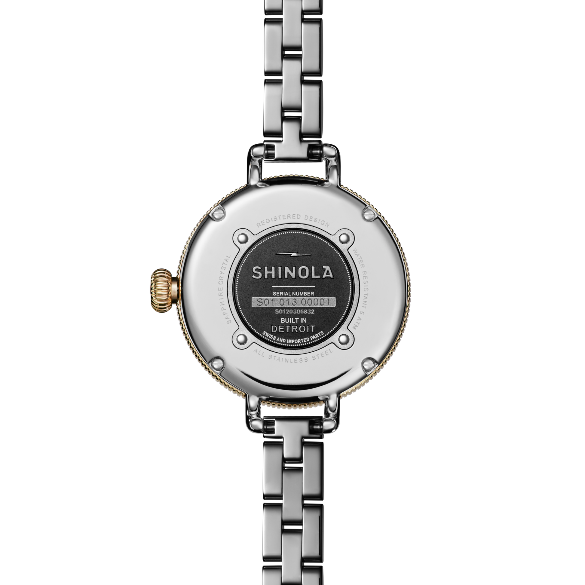 Close-up of the back of a Shinola Birdy Watch – Petoskey, featuring a two-tone gold and stainless steel case, metal link band, and visible serial number plate labeled Built in Detroit.
