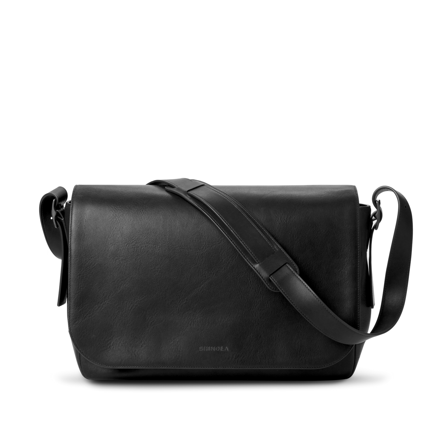The Shinola Runwell Messenger Bag in black features a flap closure, padded laptop sleeve, and adjustable crossbody strap, displayed against a plain white background.