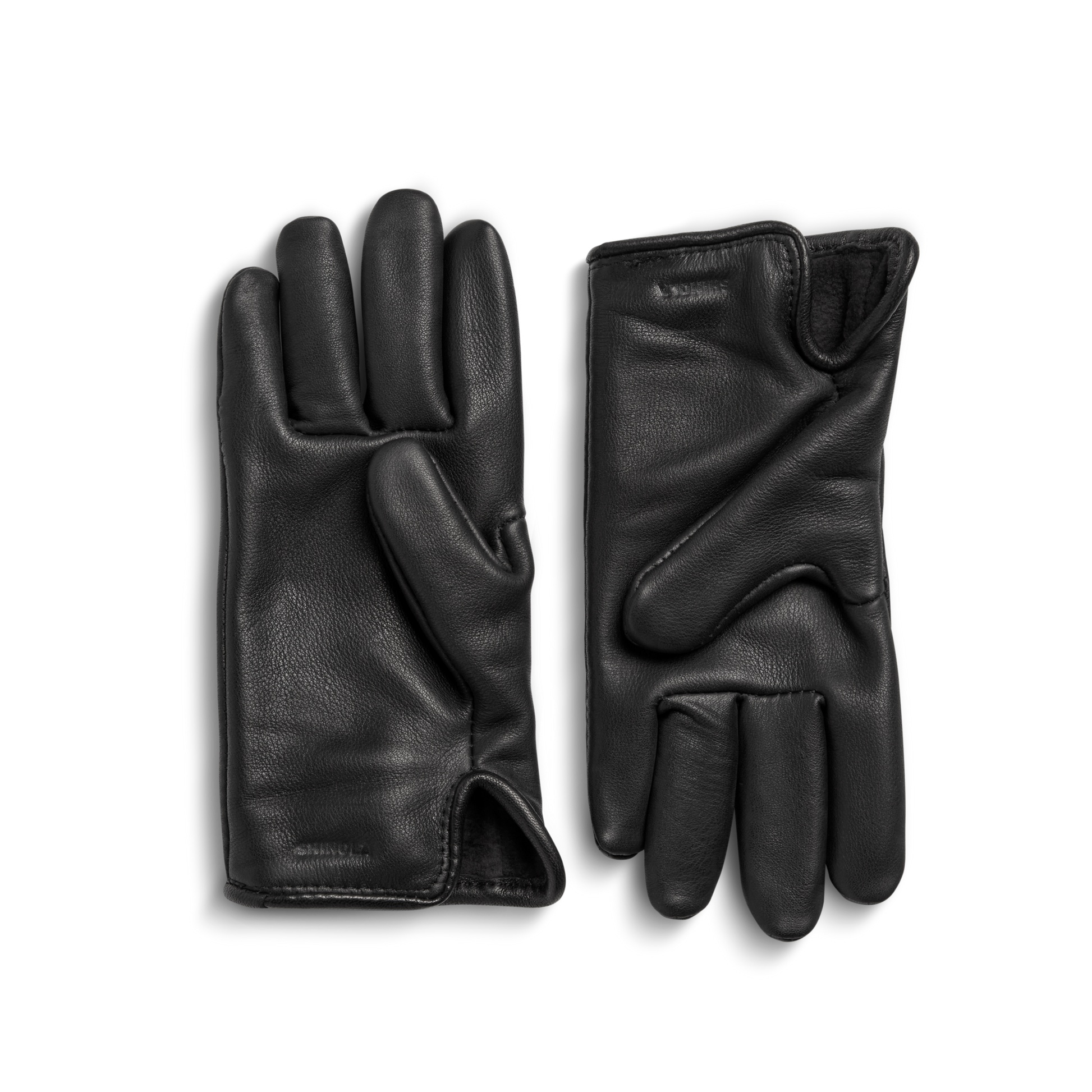 A pair of Shinola Lined Leather Gloves - Black, crafted from premium leather, are shown fleece-lined with one palm-up and the other palm-down on a light gray background.