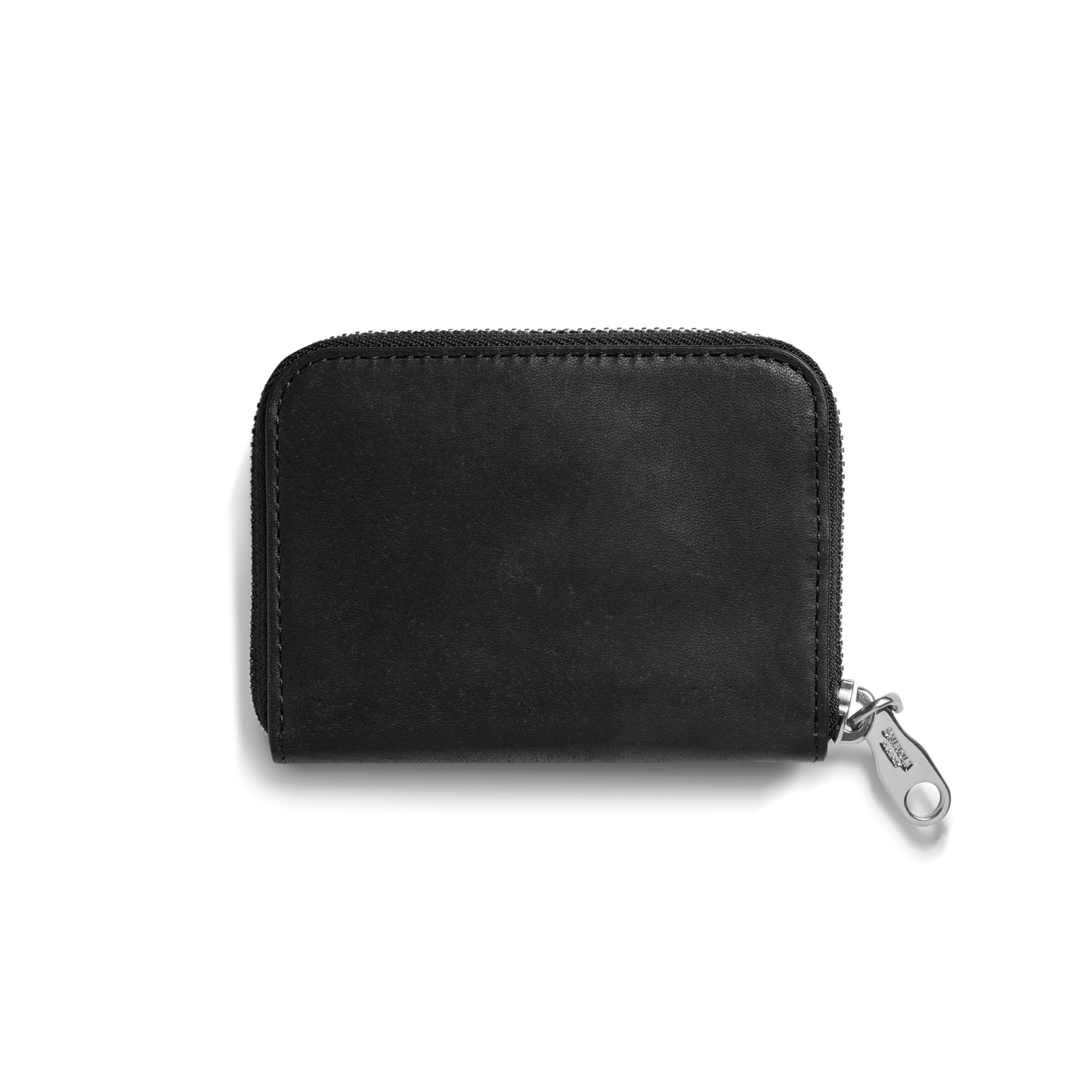 The Shinola Pocket Small Zip Around Wallet in black natural leather features rounded edges, visible stitching, and a silver zipper pull tab. Shown closed against a plain white background.