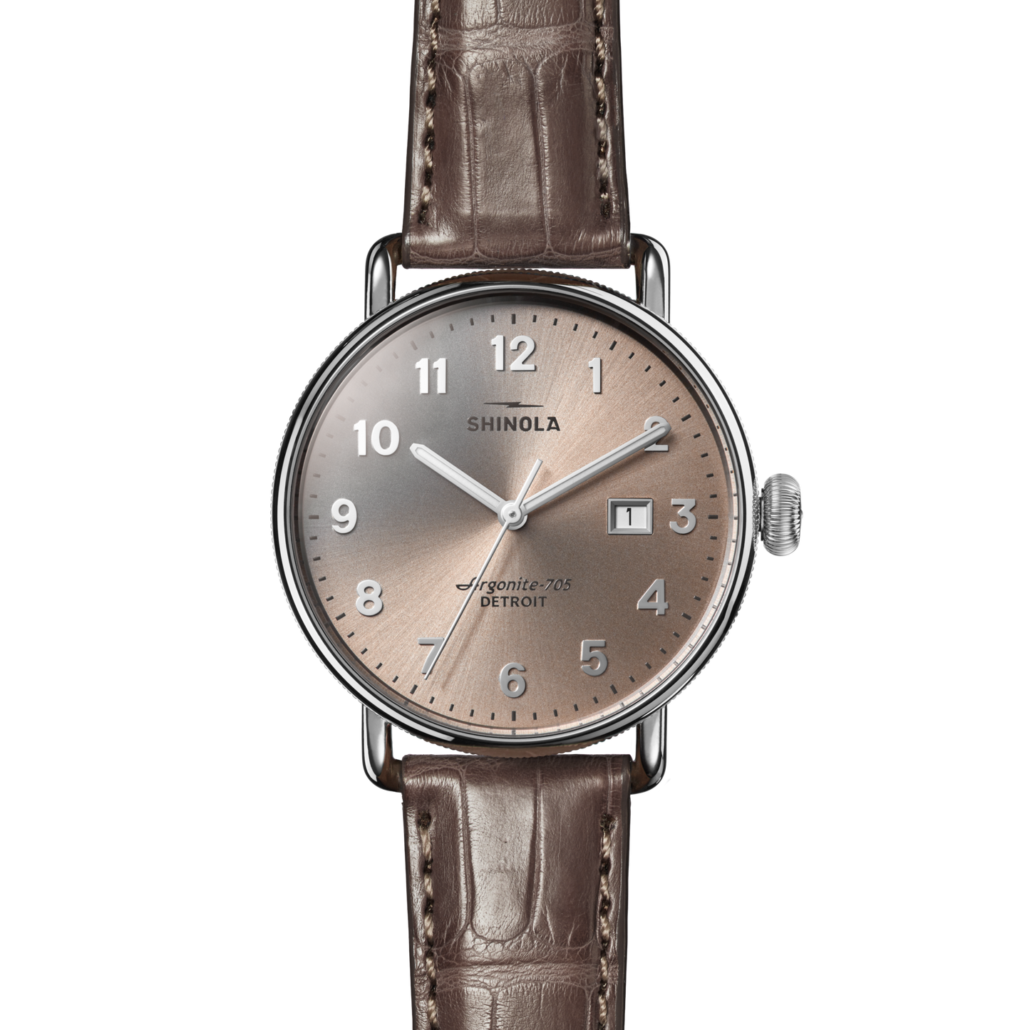 The Shinola Canfield Watch features a 38mm silver round case, gray-brown American alligator leather strap, taupe dial with silver hour markers, and date window at 3 o’clock. The dial reads “SHINOLA” and “Argonite-705 DETROIT.”.