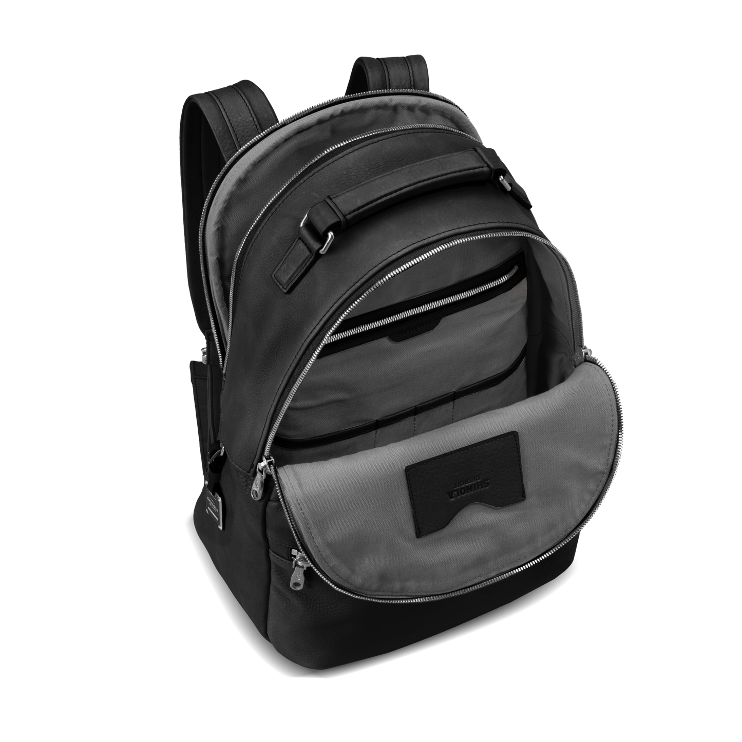 The Shinola Runwell Backpack - Black is crafted from premium natural grain leather, featuring multiple zippered compartments and organized inner pockets, shown on a plain white background.