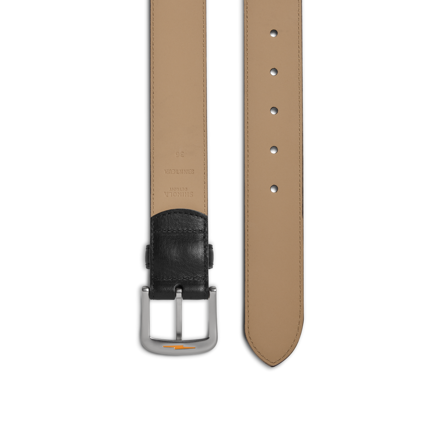 A close-up of the Shinola 1 1/2" Canfield Belt - Black shows tan Italian Vachetta leather with a black leather end, classic silver buckle, multiple adjustment holes, and visible edge stitching.