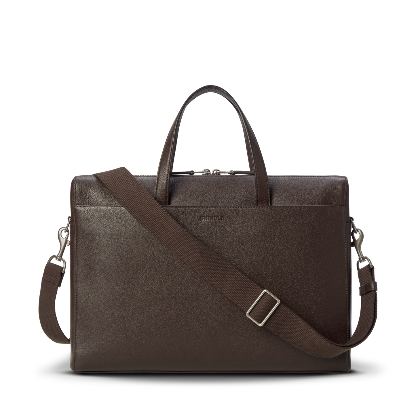 The Shinola Canfield Briefcase - Espresso features dark brown pebbled leather, a top handle, removable shoulder strap, subtle metallic hardware, and a laptop pocket, shown against a plain white background.