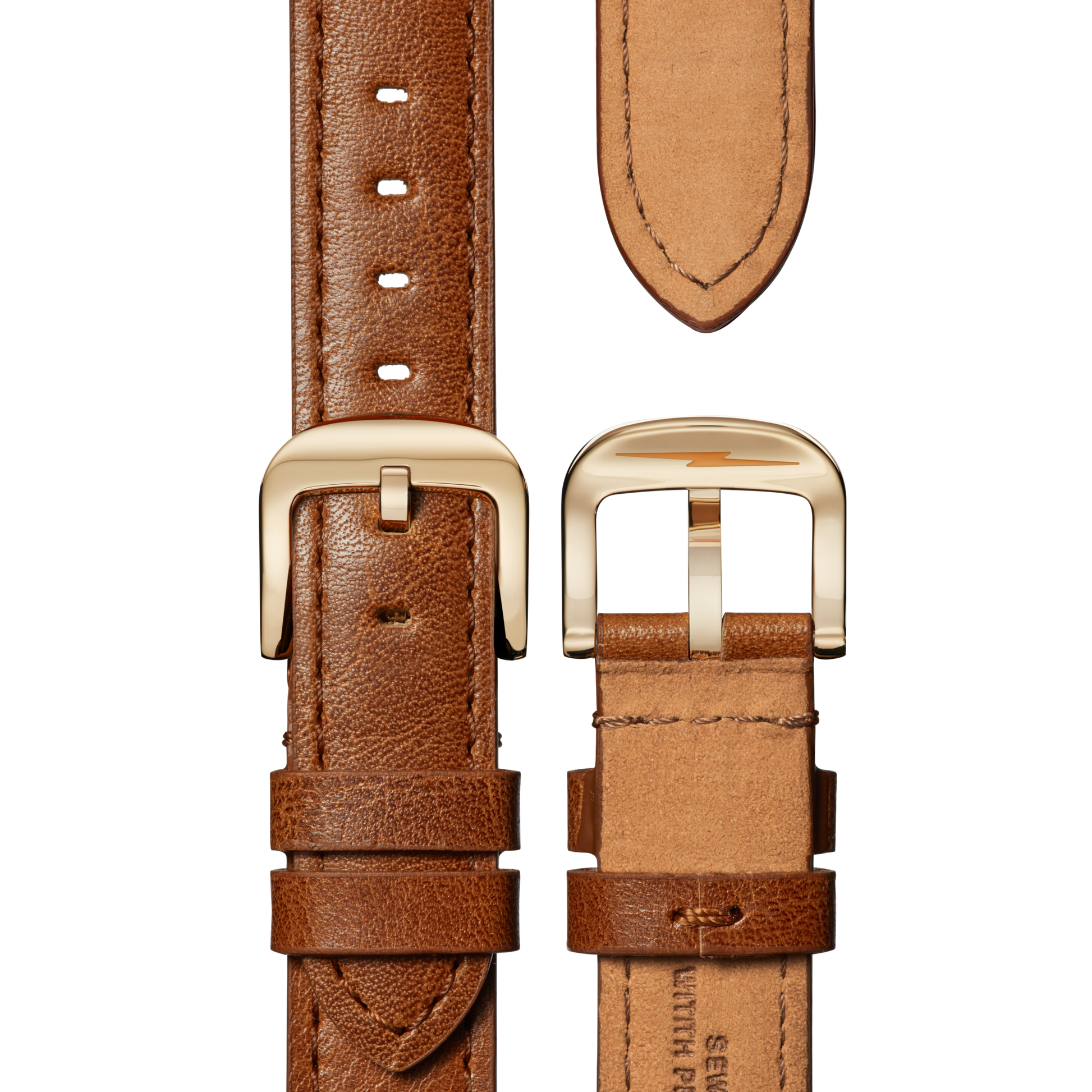 Close-up of the Shinola Canfield Watch - MOP Tan Leather Strap, showing its brown harness leather with gold-tone buckle, visible edge stitching, and multiple holes for size adjustment. Both front and back sides are displayed.