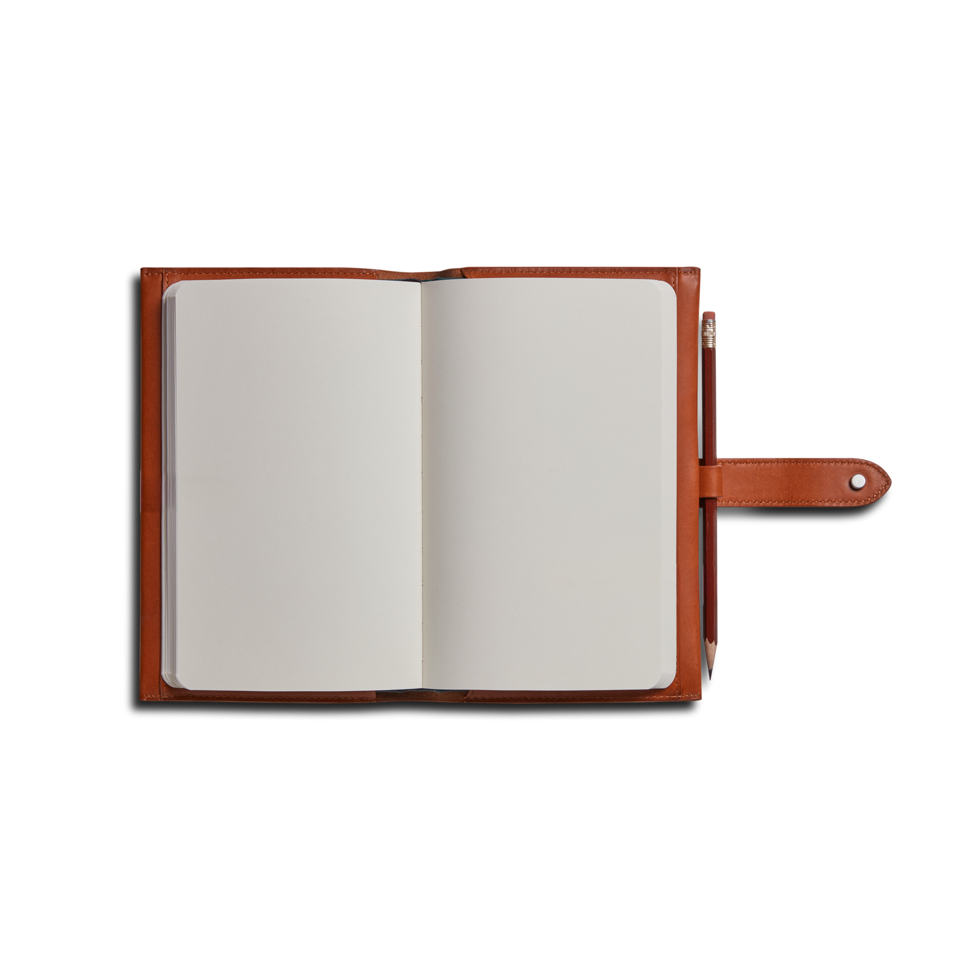 A Shinola Medium Snap Journal Cover in rust Italian leather with blank white pages, snap closure, and a pencil in the right-side loop, photographed on a white background.