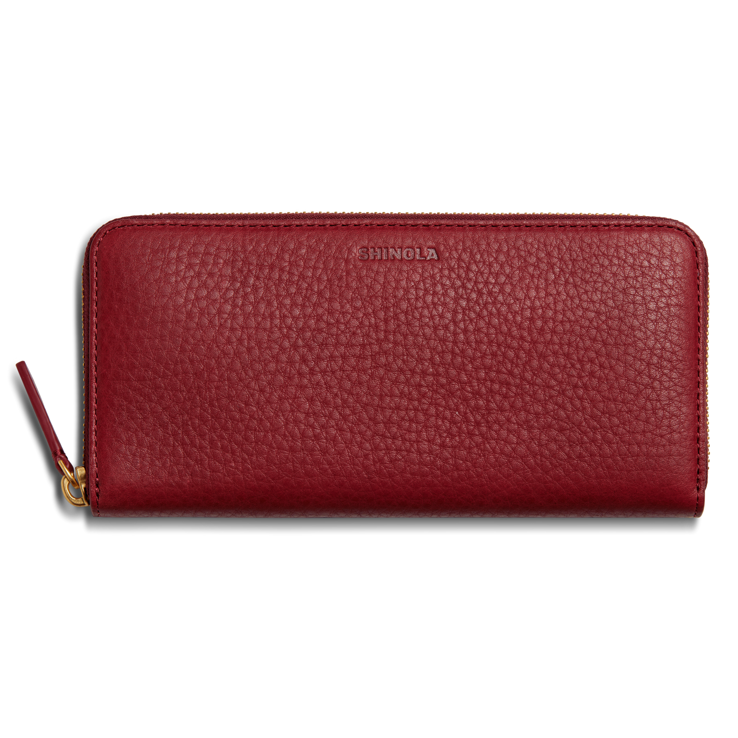 The Continental Zip Wallet - Ruby by Shinola is crafted from natural grain leather with a textured finish, card pockets, and a gold zipper pull. SHINOLA is embossed near the top center.