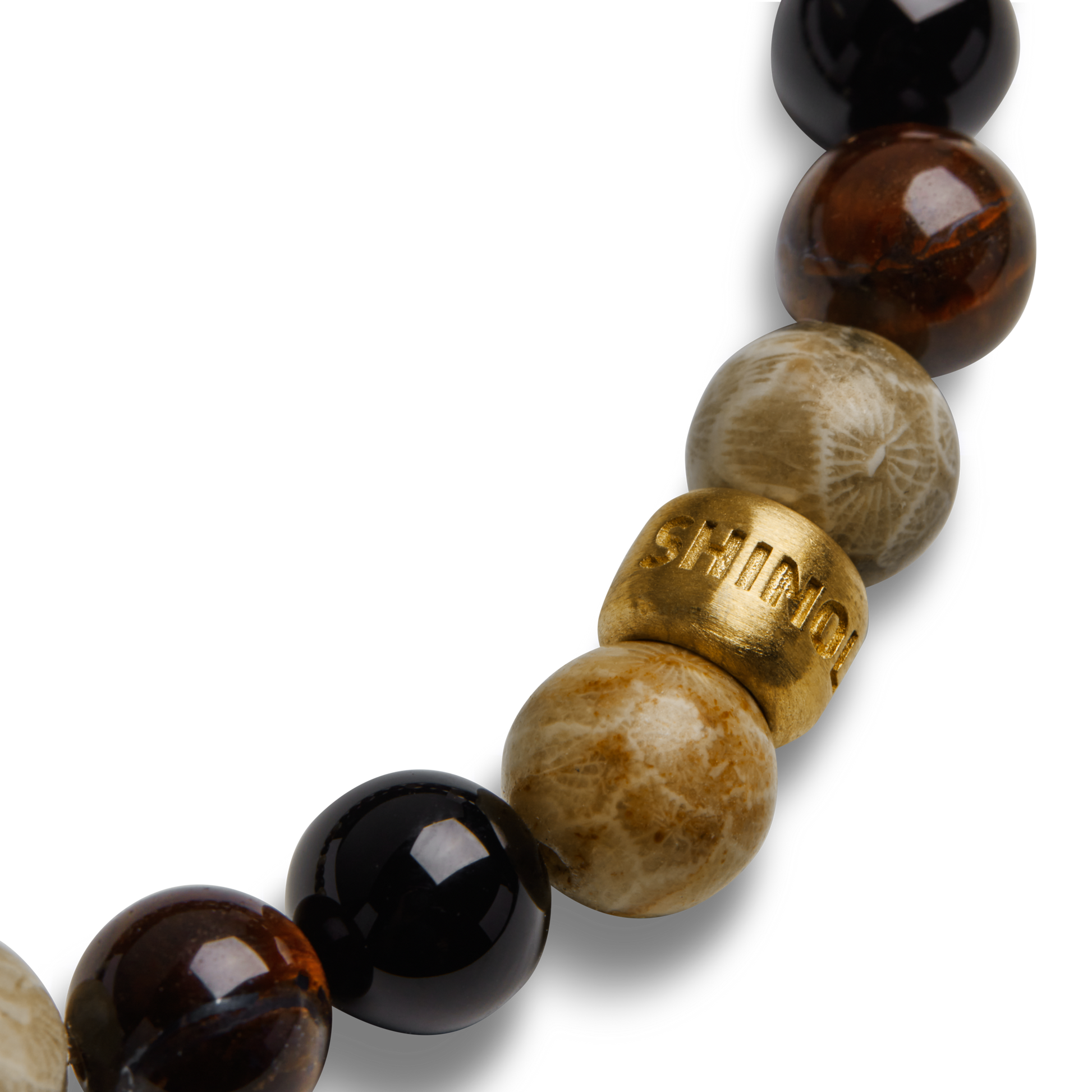 A close-up of the Shinola 8mm Beaded Bracelet Multi Stone, featuring polished black, brown, and beige stones with a single gold bead engraved with SHINOLA.