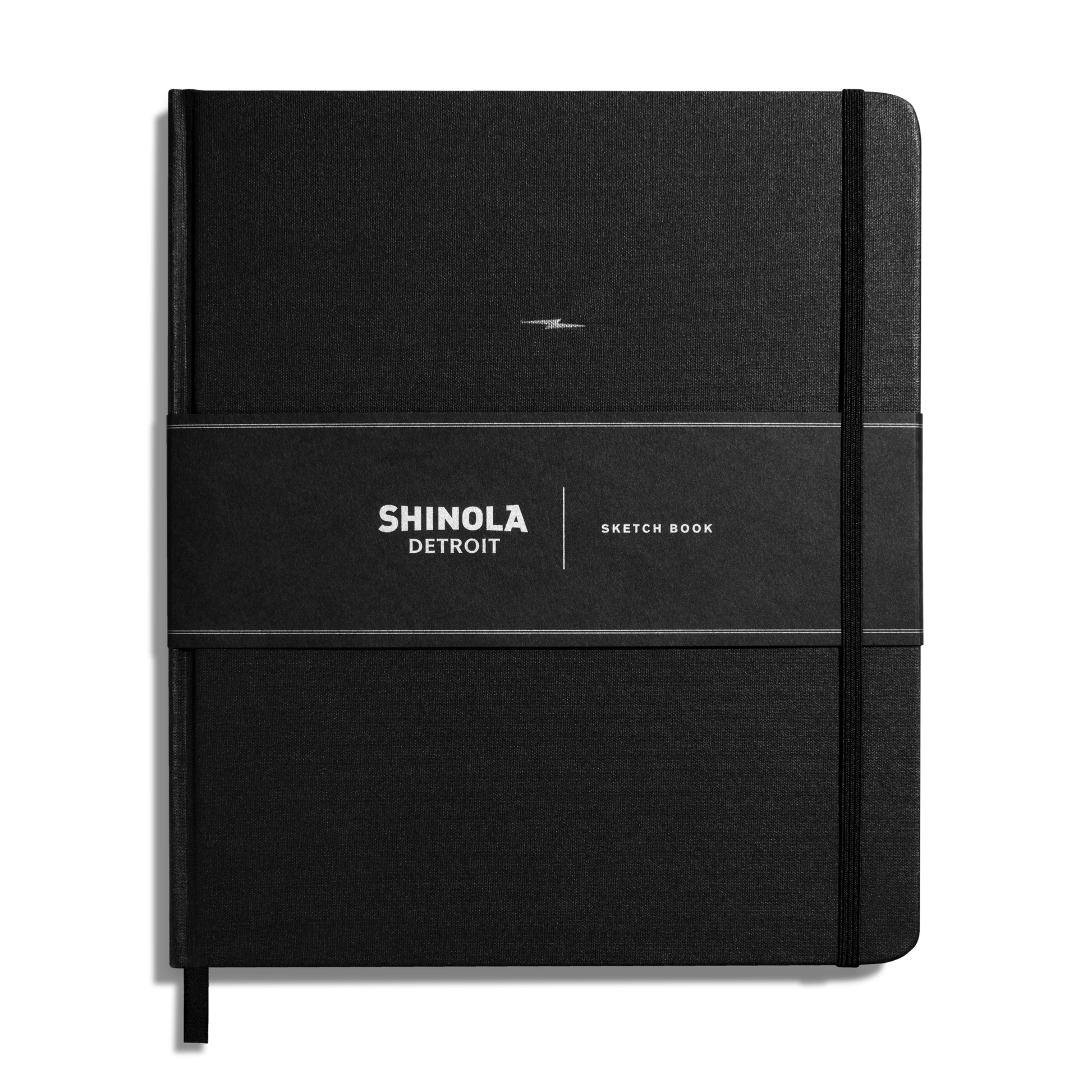 The Shinola Large Hard Plain Sketchbook - Black features a hard linen cover, elastic closure, black ribbon bookmark, branded paper band, and 100 lb premium drawing paper.
