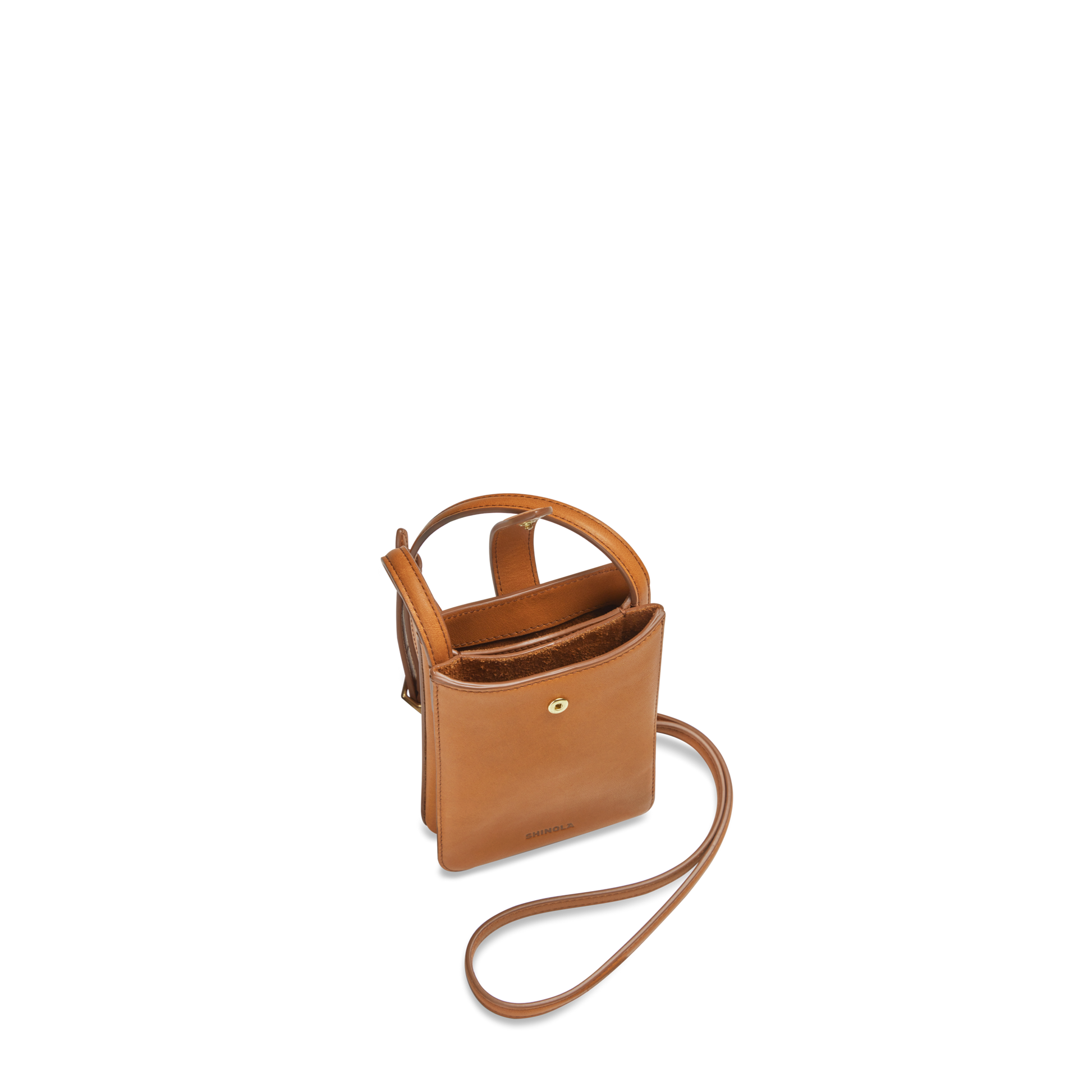 The Shinola Bixby Phone Crossbody in Tan is a small natural leather bag with a long strap, open top, and front gold button snap—ideal for traveling light. Shown upright against a plain white background.