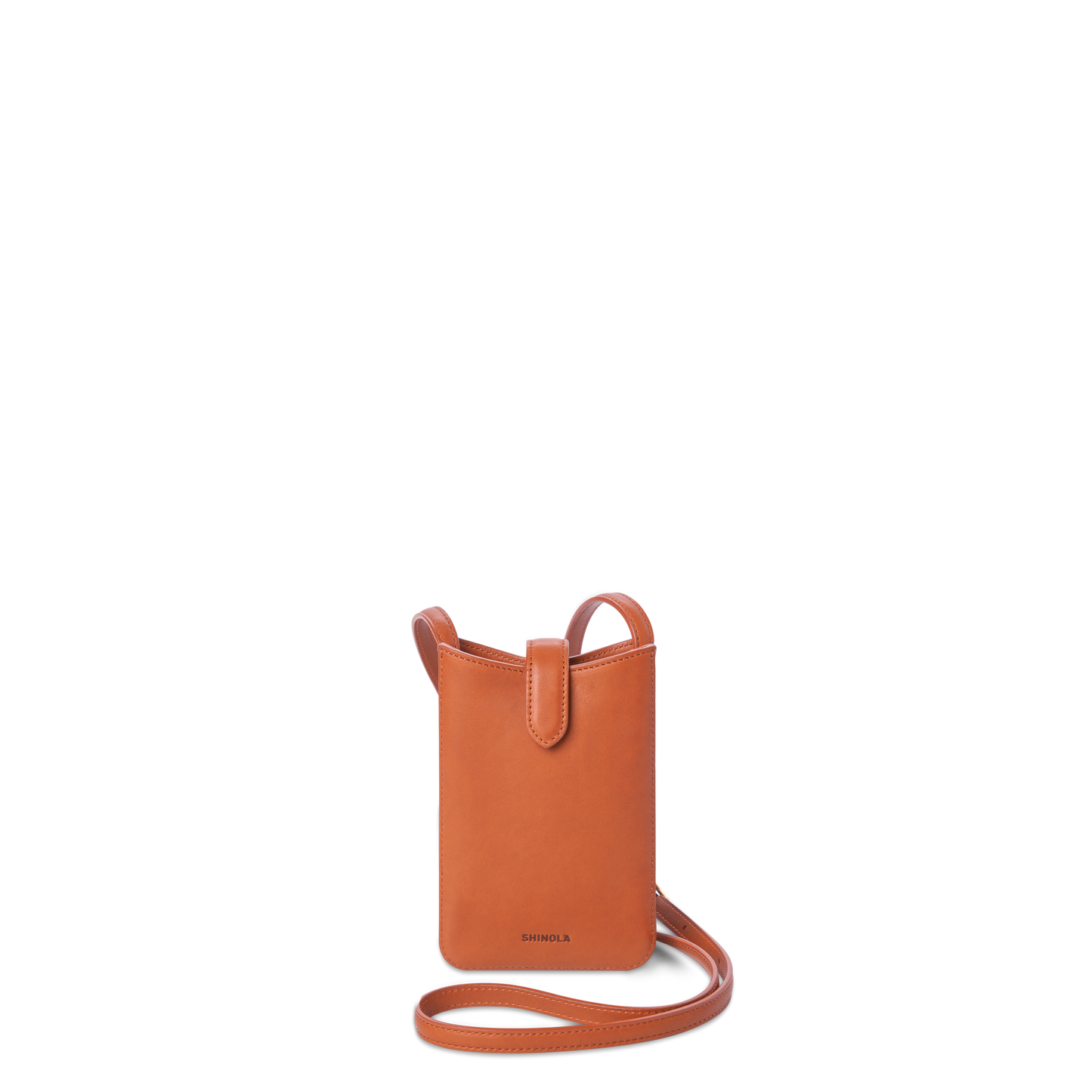 The Bixby Phone Crossbody - Rust by Shinola is a compact, rectangular bag in natural leather with a long strap and flap tab, featuring the Shinola logo embossed near the bottom.