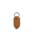 The Leather Monogram Key Fob - Tan by Shinola is a brown leather keychain with a pointed tip, silver metal ring, and the word SHINOLA embossed in the center, shown on a plain white background.