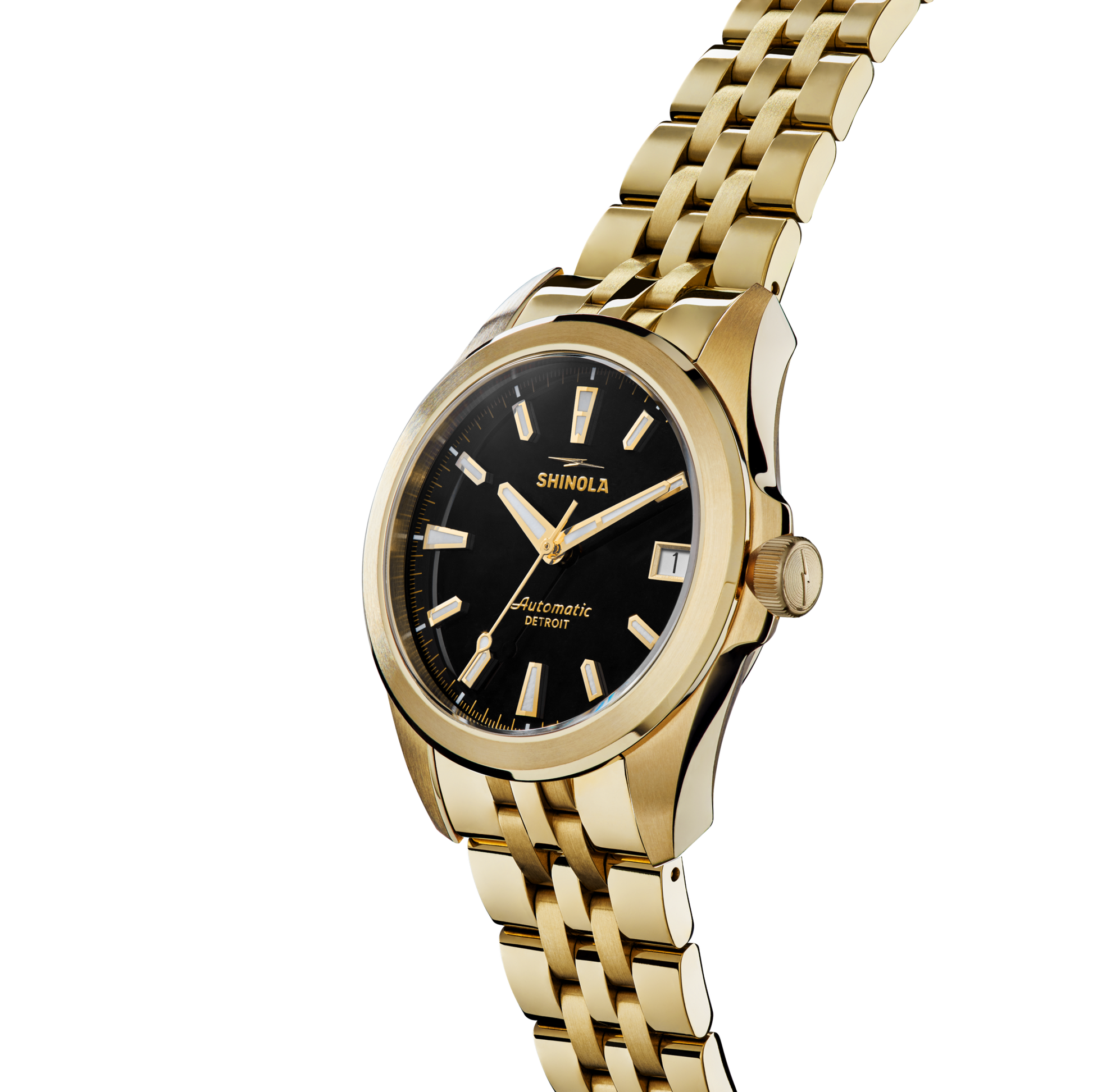 The Shinola Circadian Monster Automatic Watch in gold features a black dial with gold hour markers and hands, a gold bracelet, and "Automatic Detroit" on the face. It's photographed at an angle on a white background.