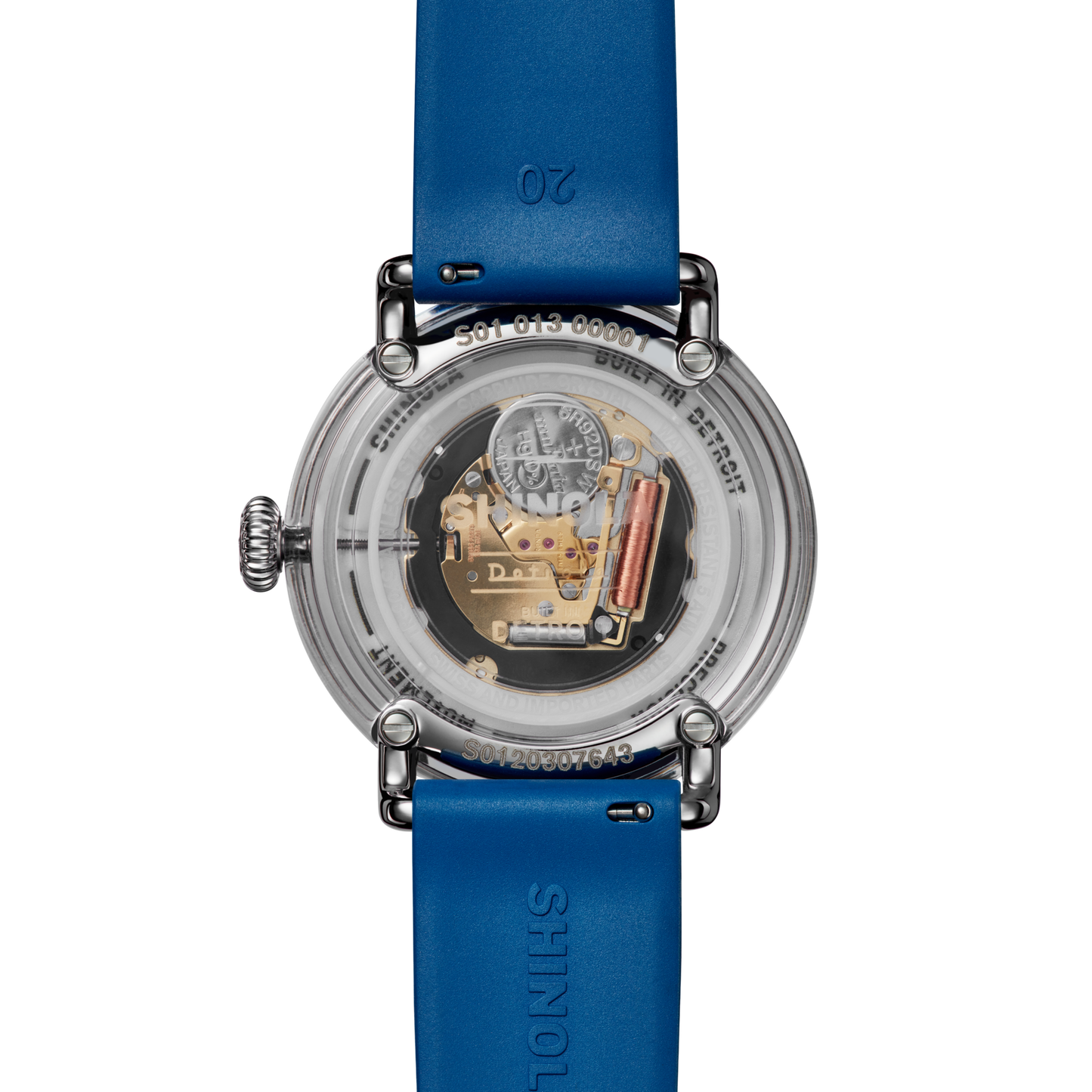 A close-up of the transparent back of the Shinola Detrola Watch - Denim Blue, revealing its internal mechanical components and intricate gears, with blue leather straps displaying the Shinola brand name.
