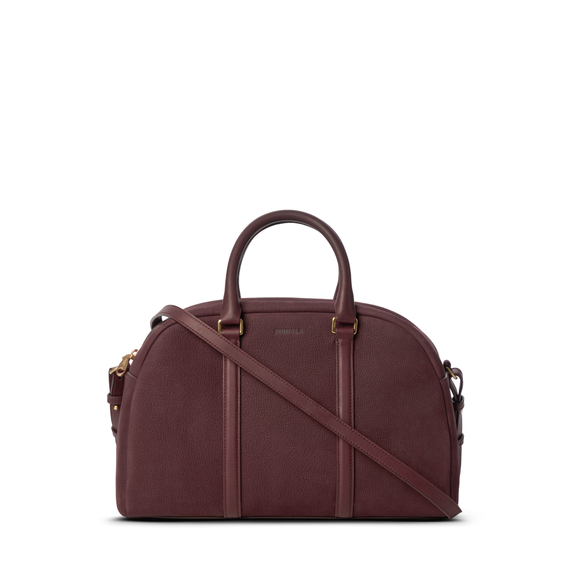 The Shinola Runwell Satchel - Merlot is a structured, dome-shaped women's crossbody with two handles, a detachable strap, gold-tone hardware, and subtle embossed branding on the front.