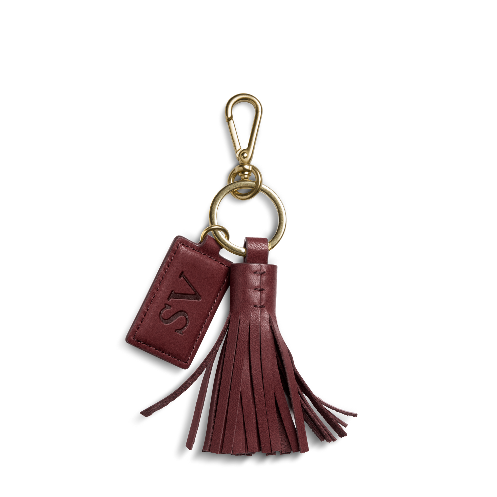 The Leather Tassel Keychain - Merlot by Shinola features a burgundy leather design with a gold clasp, tassel, and a small tag embossed with SV.