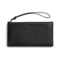 The Shinola Wristlet Wallet - Black features textured natural grain leather, card pockets, zipper closure, and a detachable wrist strap. "Shinola" is embossed on the front. Shown on a white background.