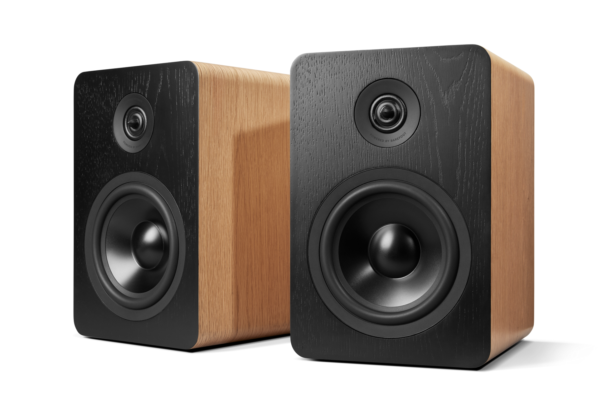 Two Shinola Bluetooth Bookshelf Speakers - Natural with wood grain finish and black fronts are side by side on a white background. Each professional speaker features both a woofer and a tweeter.