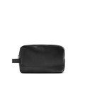 The Shinola Zip Travel Kit - Black is made from natural grain leather with a pebbled texture, featuring a zipper closure and side handle, shown on a plain white background.