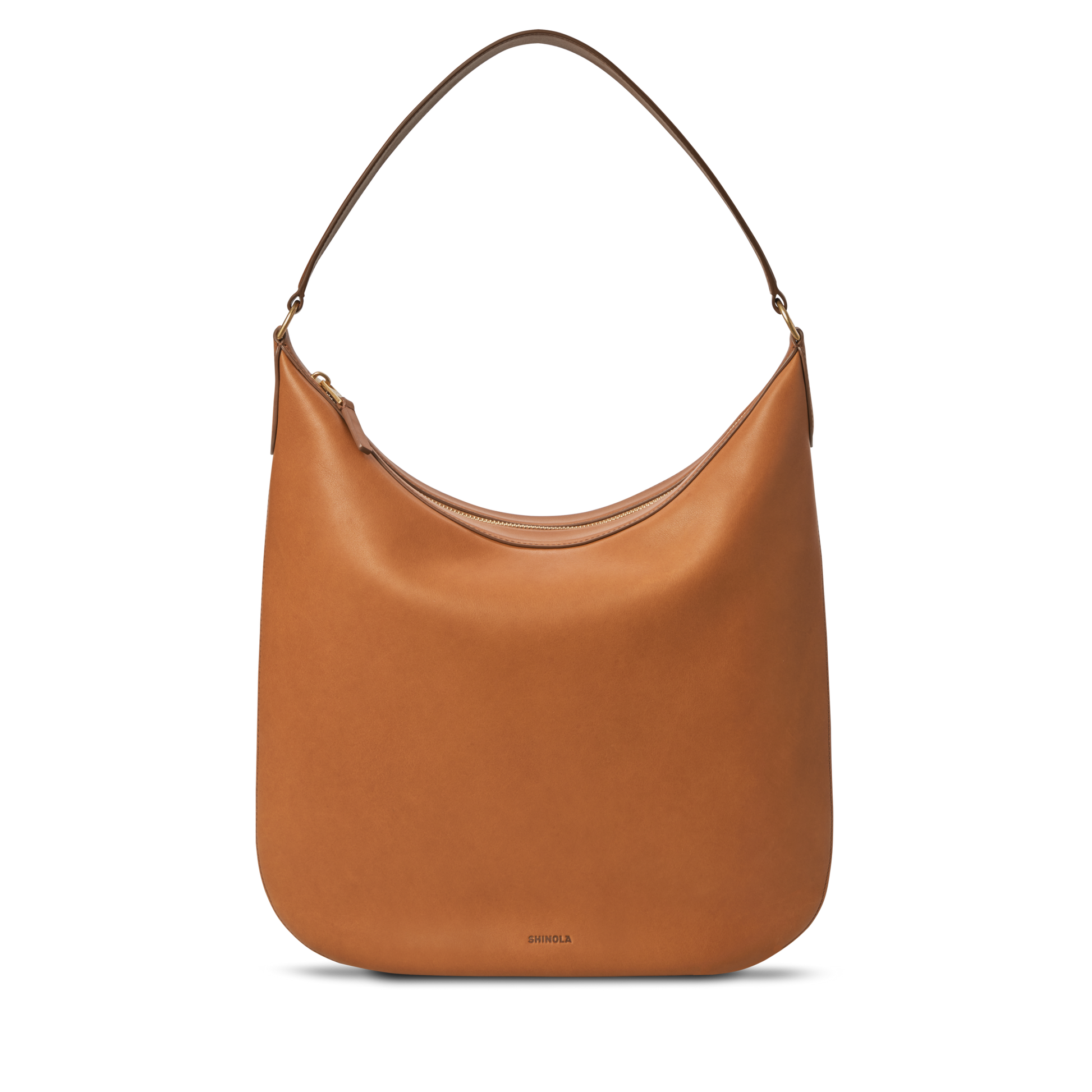 The Shinola Bixby Shoulder Bag - Tan features natural leather, an accordion-style build, single shoulder strap, curved top, and a minimal design, displayed against a plain white background.