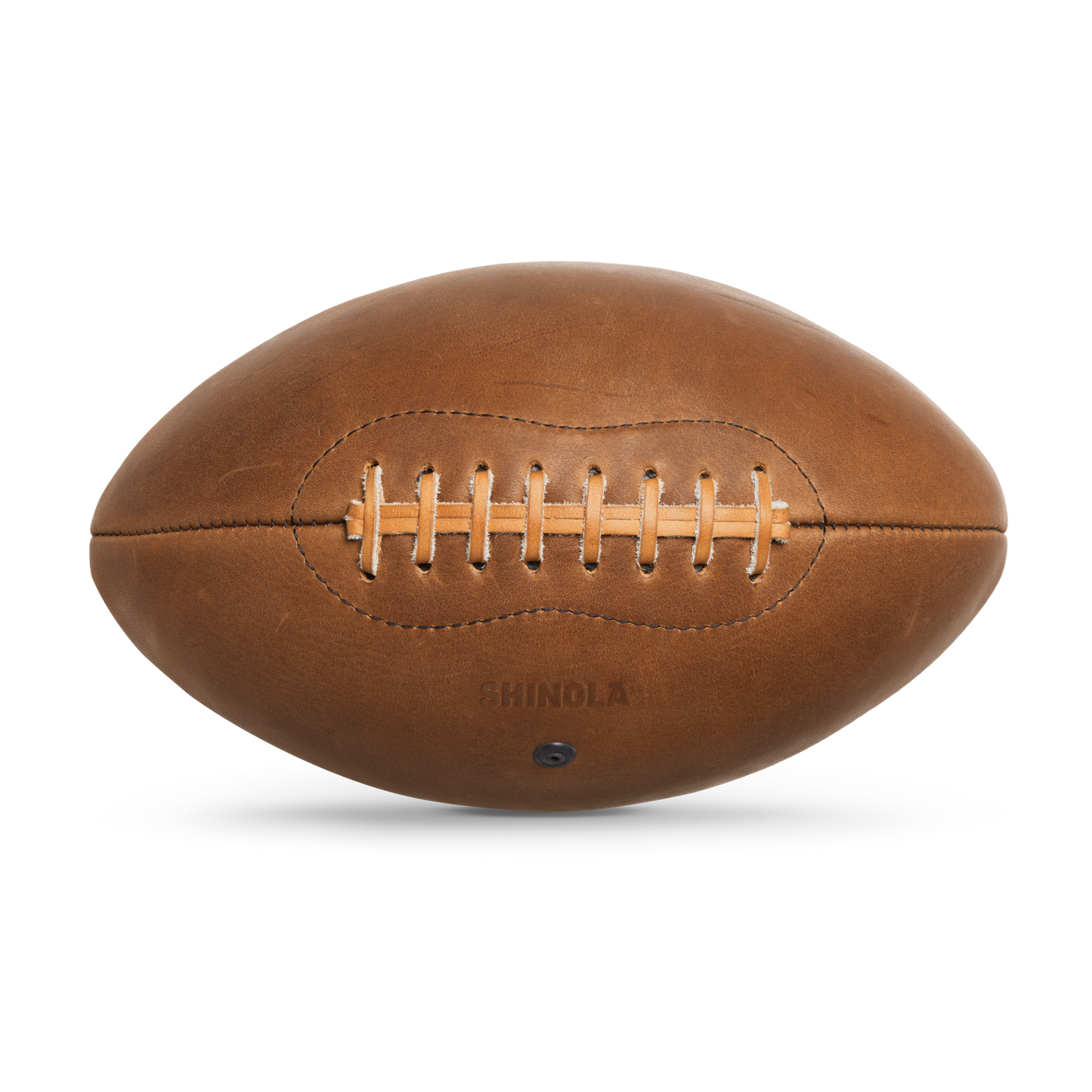 The Shinola Leather Football - British Tan features tan laces, visible stitching, and "Shinola" embossed on the surface. It is displayed against a plain white background.