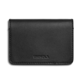 The Shinola Business Card Holder - Black is crafted from Italian leather and features the SHINOLA logo embossed on the front, displayed against a white background.