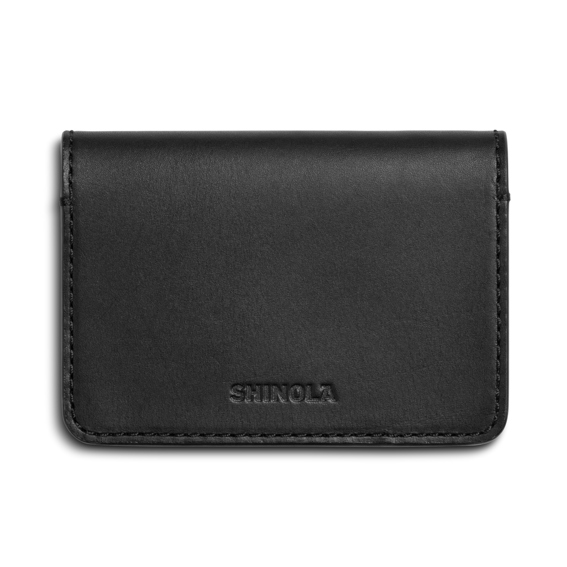 The Shinola Business Card Holder - Black is crafted from Italian leather and features the SHINOLA logo embossed on the front, displayed against a white background.