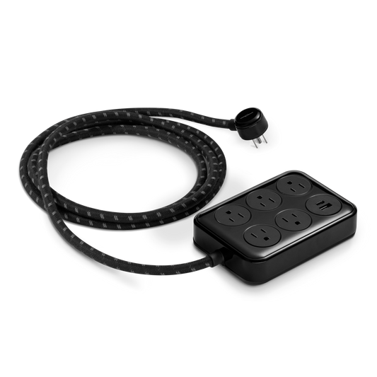 The Shinola 5 Port Power Supply in black, featuring a custom braided extension cord, six outlets, and USB-A/USB-C charging ports, is displayed on a white background.