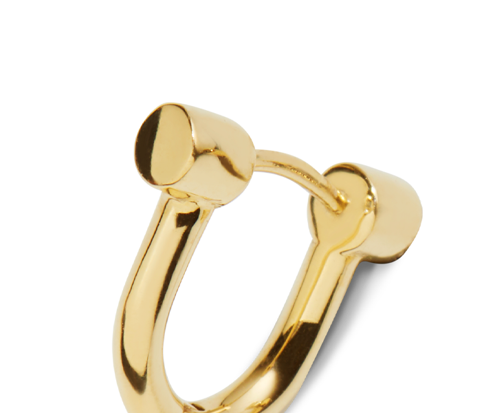 Close-up of Shinola's Bike Lock Huggie Earrings in Yellow Gold—these sleek, U-shaped earrings with rounded ends are set against a plain white background, exemplifying modern design.