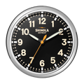 A Shinola 14" Runwell Clock - Black features a black face, white numbers, chrome casing, white hour and minute hands, an orange second hand, and "Shinola Detroit" below the 12. The time shown is 10:09:33.