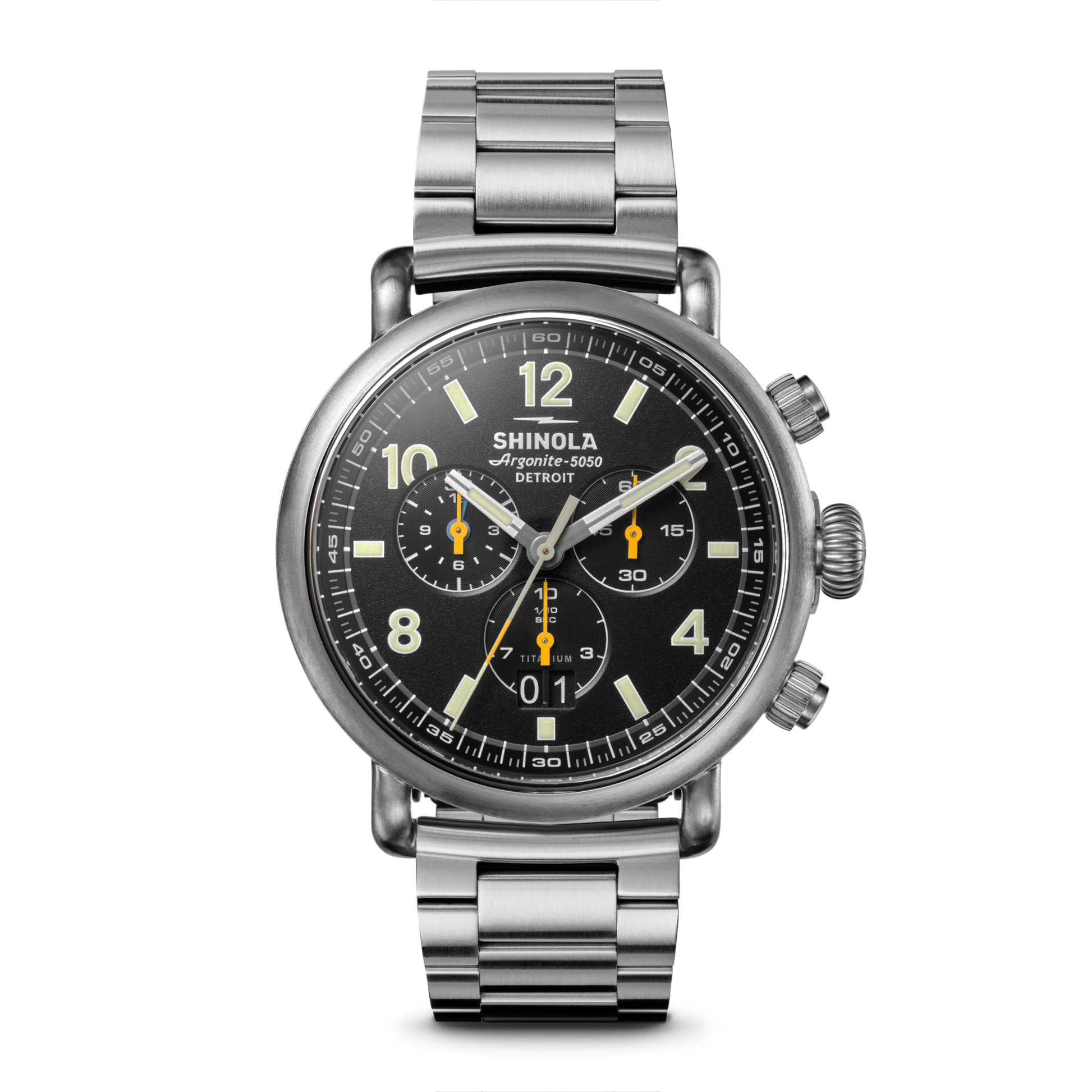 The Shinola Runwell Chronograph West Wind Watch Gift Set features a stainless steel case, black dial with silver hands and yellow accents, three subdials, a metal link bracelet, water resistance to 20 ATM, plus an extra strap. Shown on white.