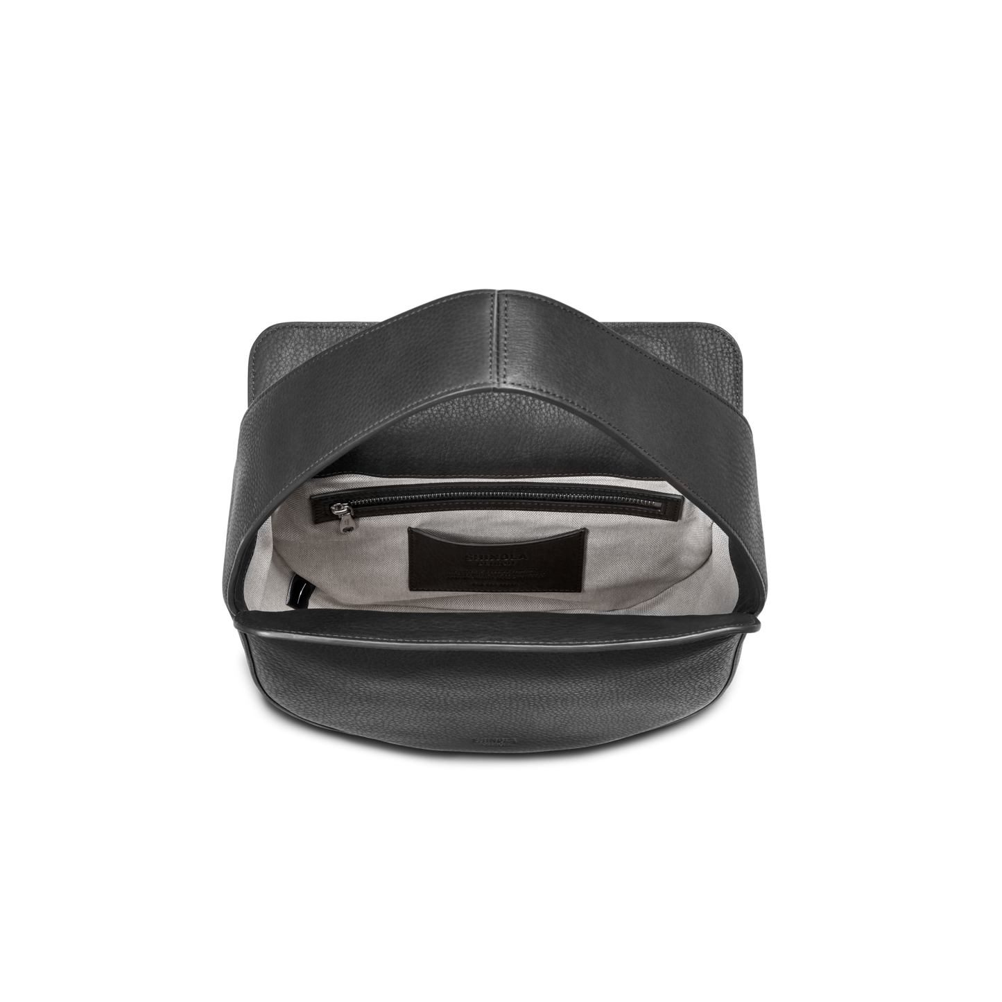The Shinola Small Shoulder Bag - Black features natural grain leather, a spacious beige interior with a zippered pocket and label, and showcases a simple, modern design with clean lines when viewed from above.