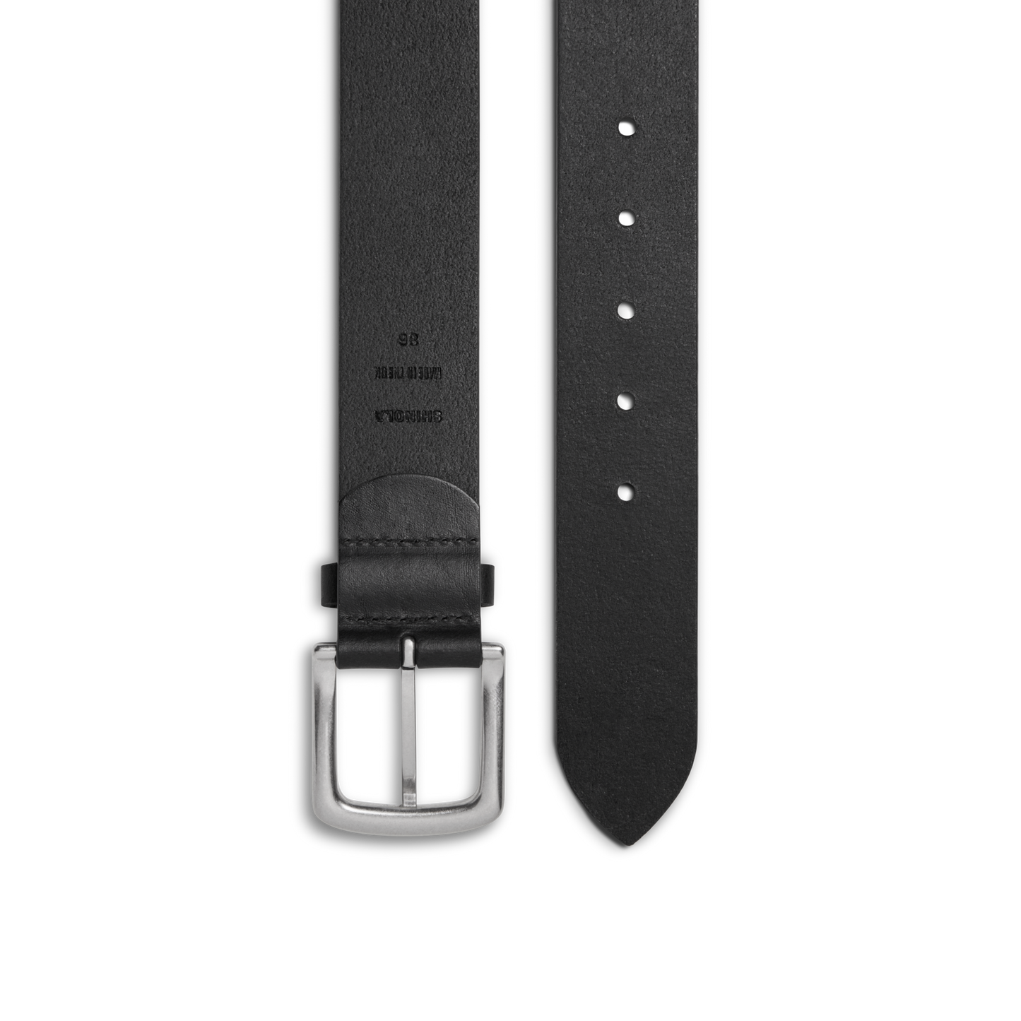 The Shinola 1 1/2" Essential Belt in black natural leather features a silver rectangular buckle, punched holes for adjustable fit, and embossed sizing and branding details on one end.