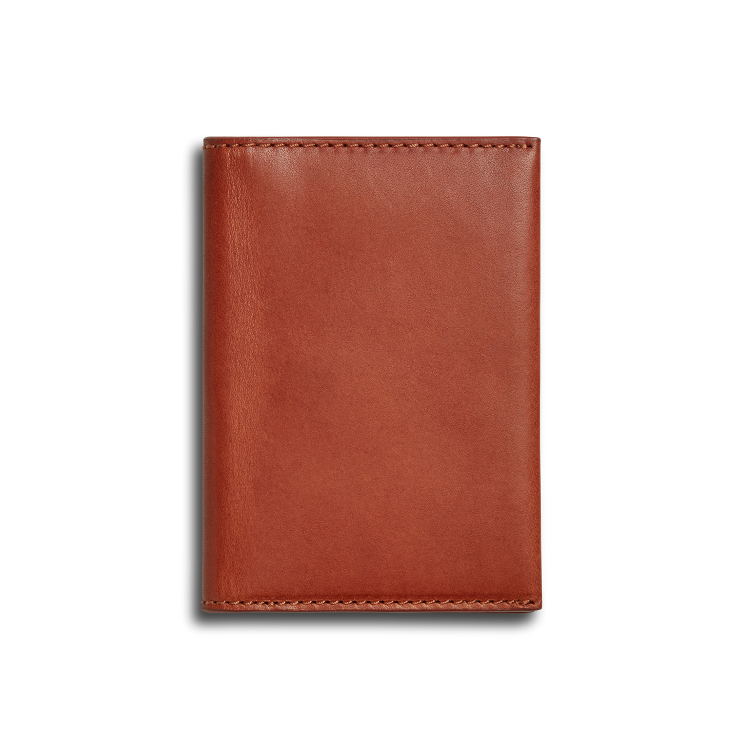 The Shinola Folded Card Holder - Rust is a closed, rectangular wallet crafted from Italian Vachetta leather with visible edge stitching, shown against a plain white background.