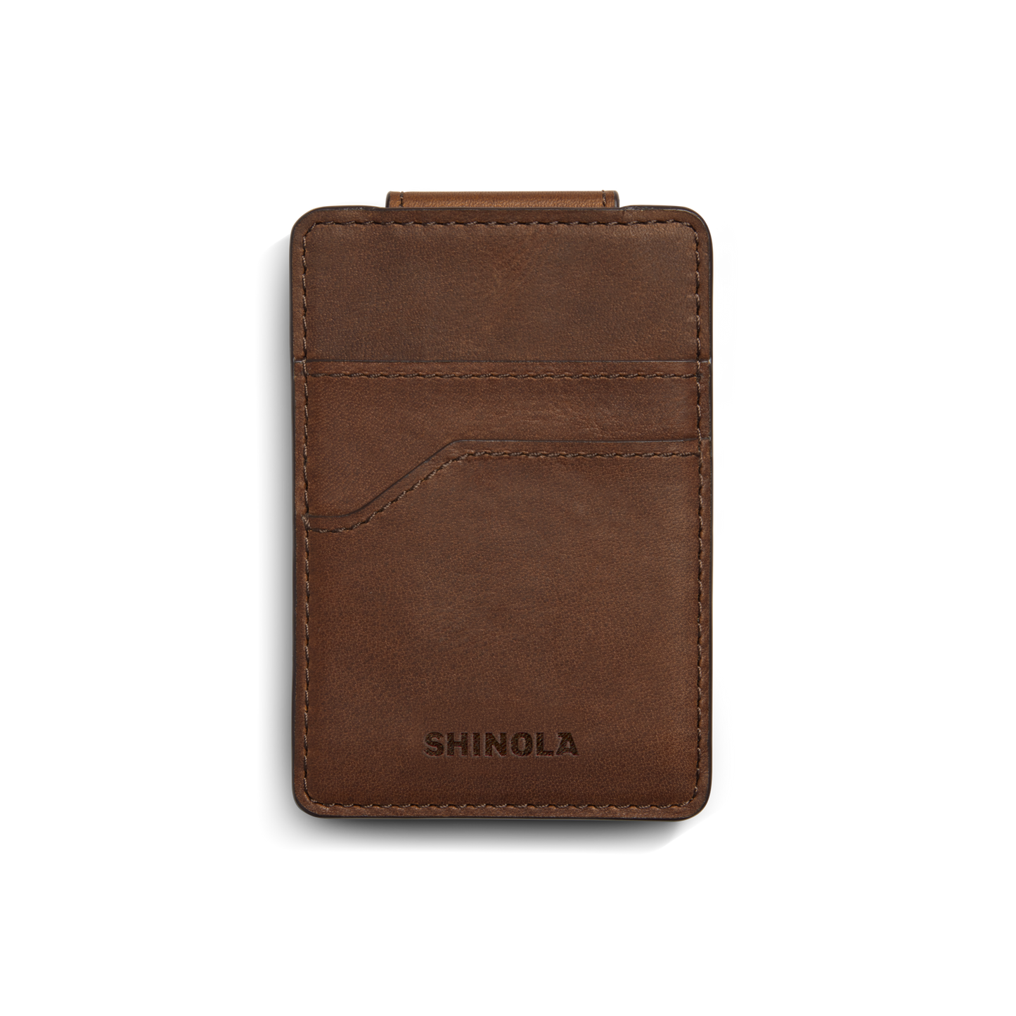 A medium brown Shinola Magnetic Money Clip Card Holder with visible stitching, two credit card slots, and the brand name embossed at the bottom, shown on a white background.