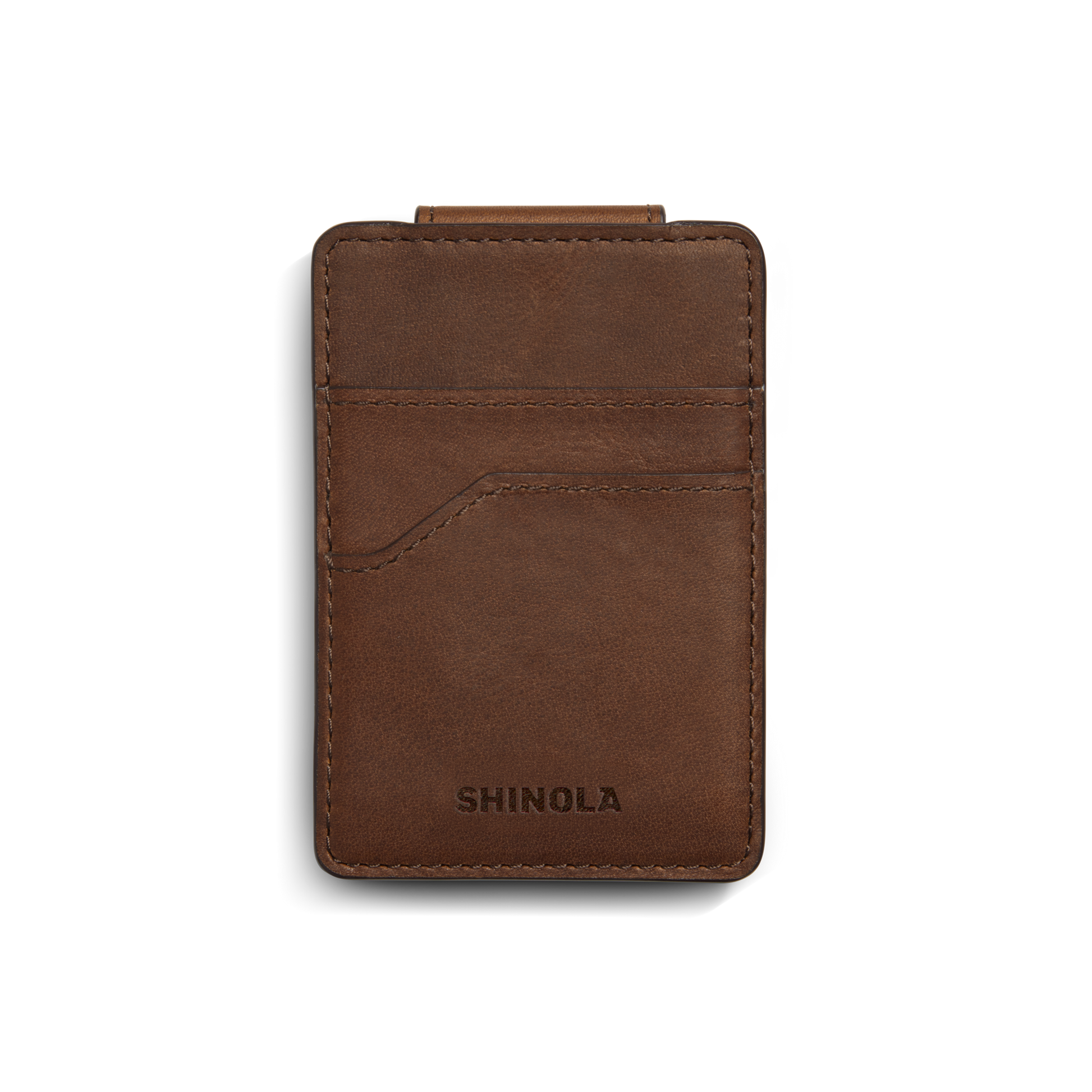 A medium brown Shinola Magnetic Money Clip Card Holder with visible stitching, two credit card slots, and the brand name embossed at the bottom, shown on a white background.