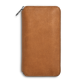 The Shinola Organizer Wallet - Tan is a closed rectangular travel wallet in light brown natural grain leather, featuring a zipper along the top and right edges, shown against a plain white background.