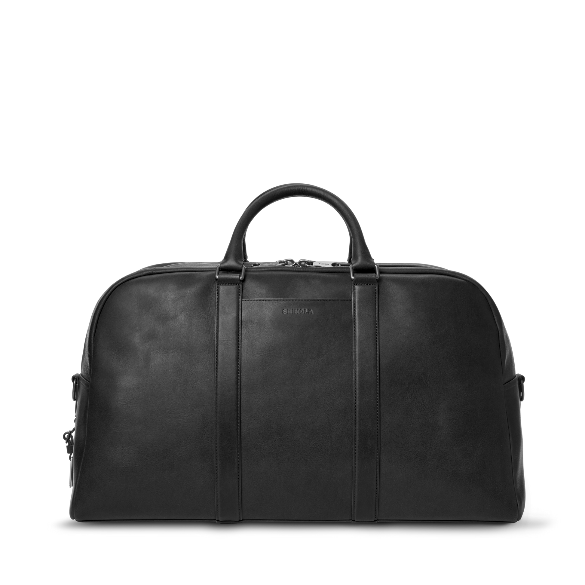 The Shinola Runwell Duffle Bag - Black is a premium carry-on crafted from Navigator leather, with two handles, a zippered top, and a minimalist design, shown against a plain white background.